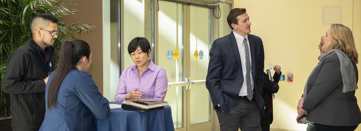 Group of mentors and mentees chatting about the program