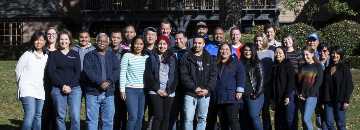 Large group of members of the program posing in front of the lodge in a group photo.